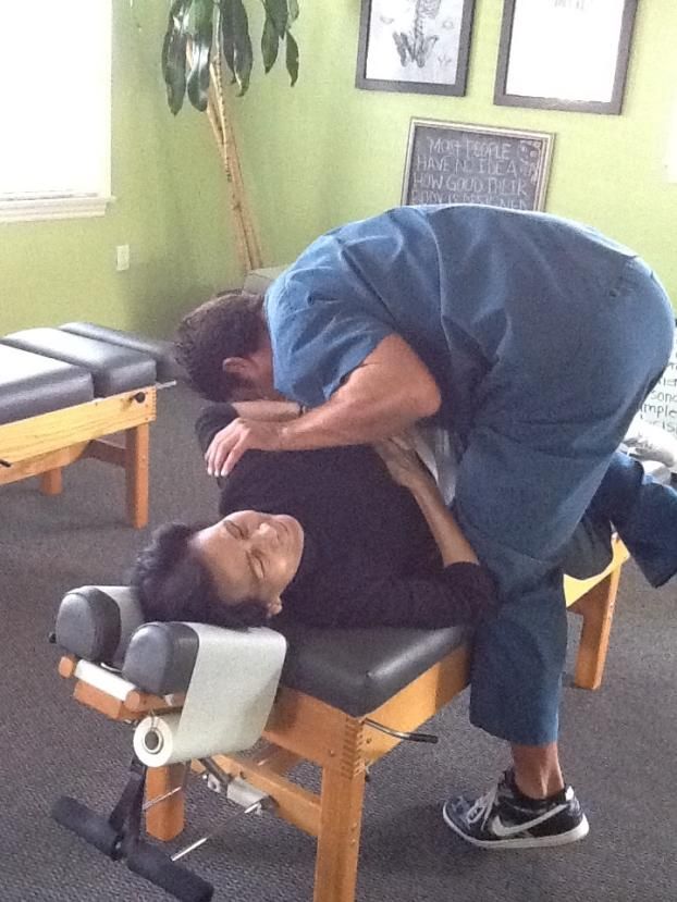 Dr. Biscotti of South Bay Family Chiropractic is performing chiropractic care for back pain in this chiropractor adjustment photo.